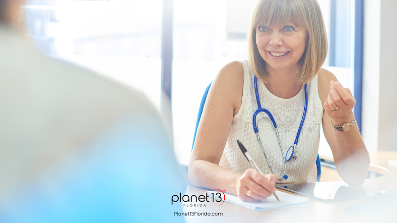 Female doctor wearing a stethoscope during a patient consultation.