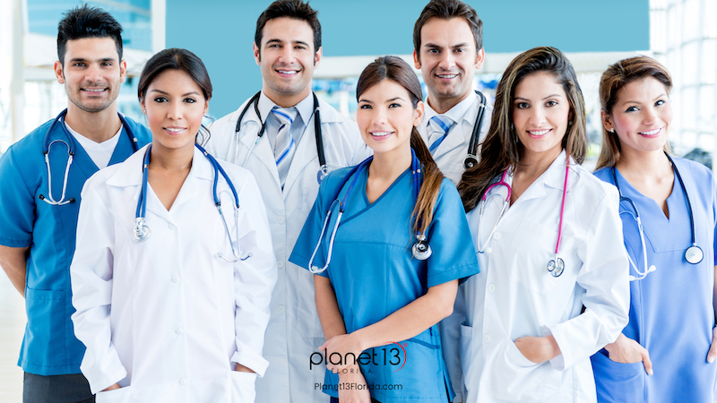 Group of doctors and healthcare professionals standing together in a medical office.