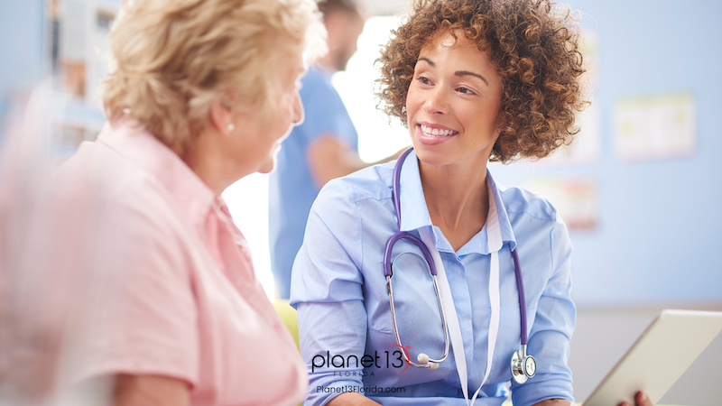 Female doctor speaking with an older patient in a medical office.