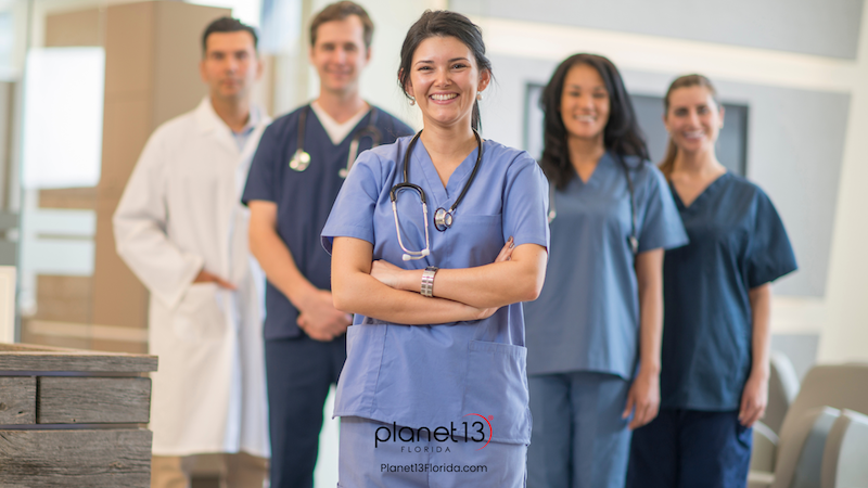 Team of doctors and nurses standing together in a healthcare setting.